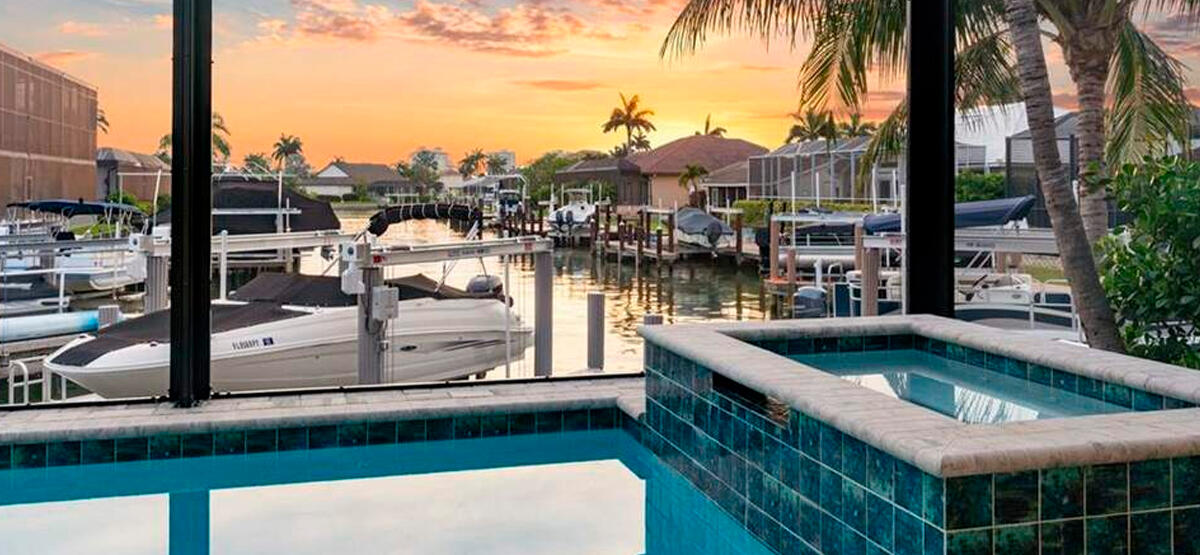 image of a boat on marco island, with a indoor pool and jacuzzi, beautiful sunset on the background.